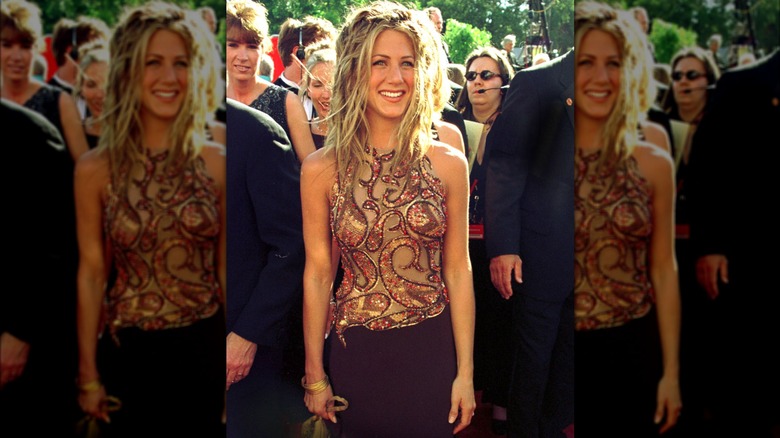 Jennifer Aniston smiling while wearing a glittery top at the Emmys