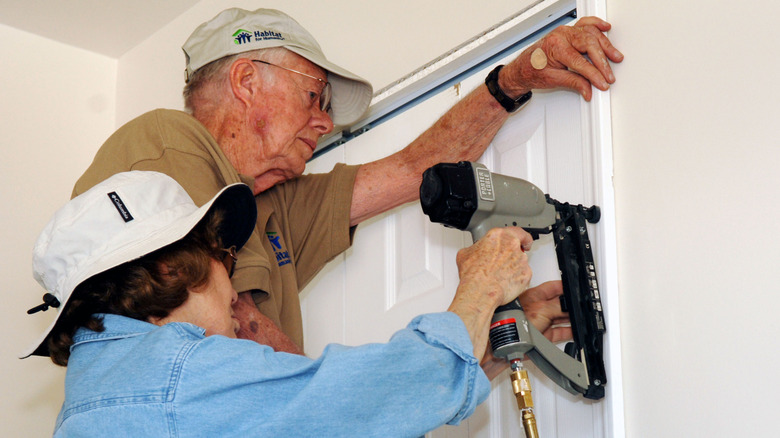 Jimmy and Rosalynn Carter work together to build homes for Habitat for Humanity in 2005