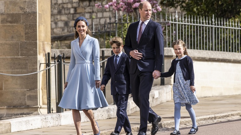 Prince and Princess of Wales walking with children 