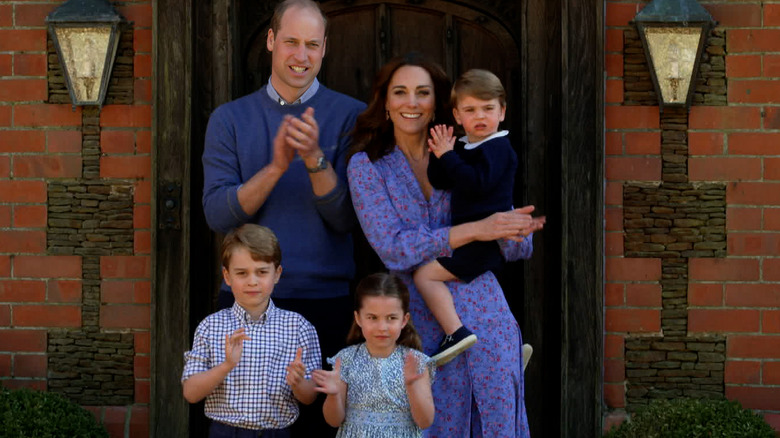 The Wales family clapping outside home 