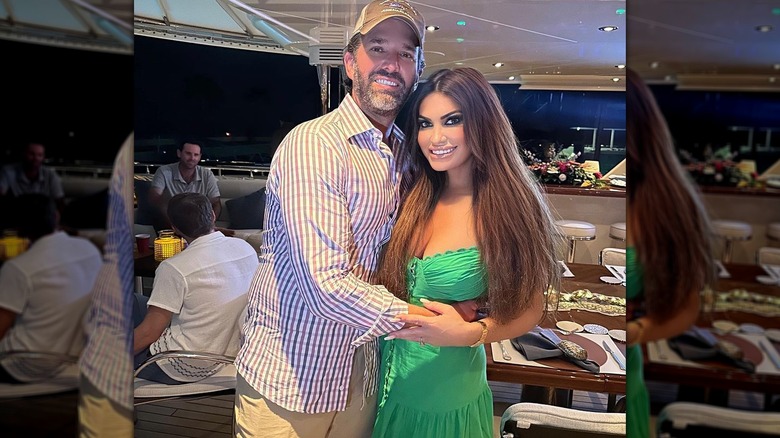 Donald Trump Jr. holding Kimberly Guilfoyle green dress