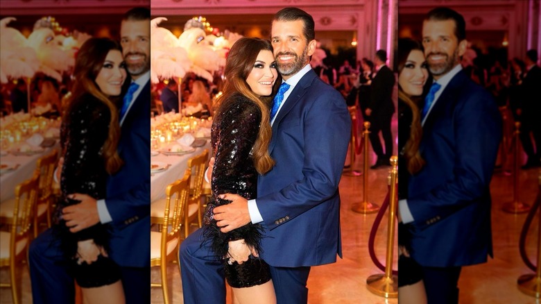 Donald Trump Jr. holding Kimberly Guilfoyle tightly in banquet hall