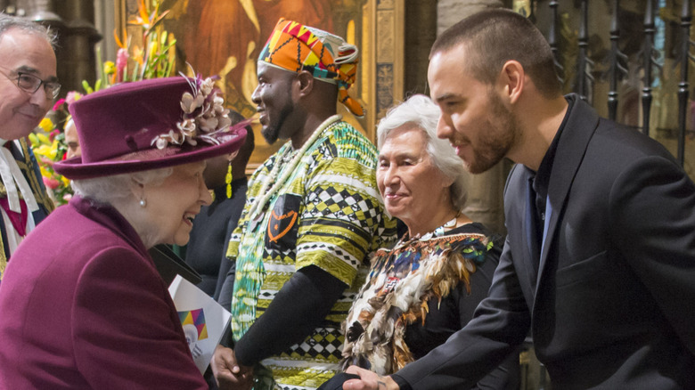 Queen Elizabeth II shaking hands with Liam Payne