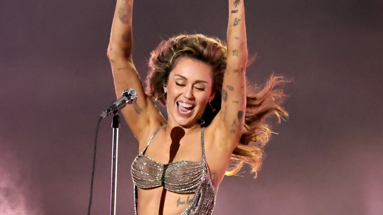 Miley Cyrus performing, smiling