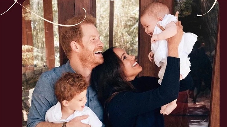 Harry and Meghan smiling with their children