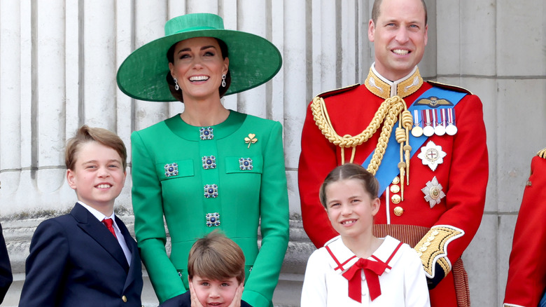 Prince William and Kate Middleton smiling with kids