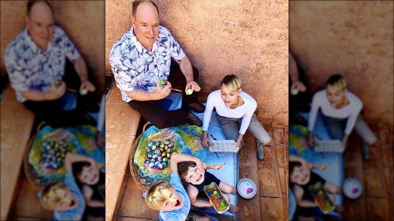 Family photo with Charlene and Albert painting eggs