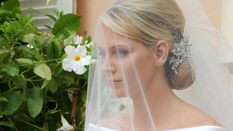 Princess Charlene wearing veil, looking on