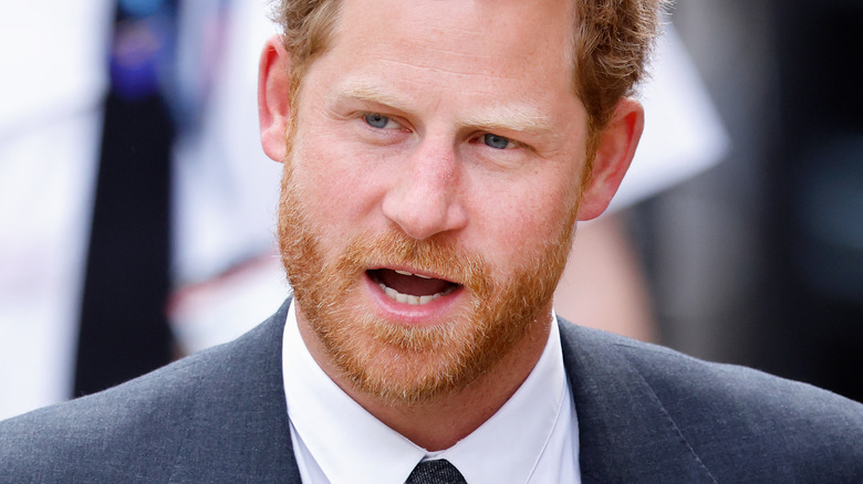 Prince Harry avoiding eye contact with the camera