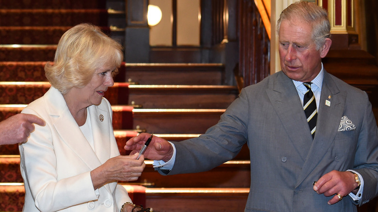 Charles examines the problematic pen