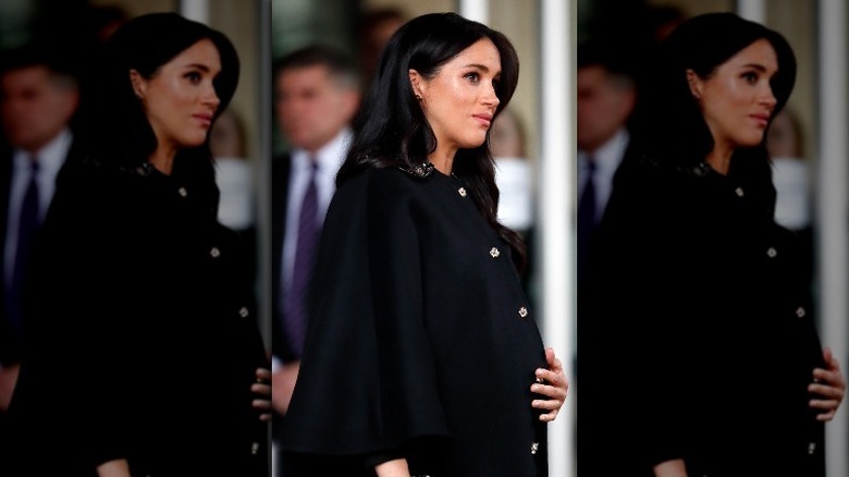 Meghan Markle cradling her baby bump