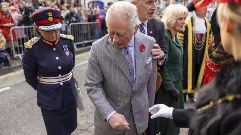 Charles looking at eggshells on ground 