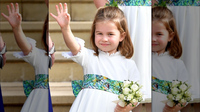 Princess Charlotte waving and dressed as a flower girl