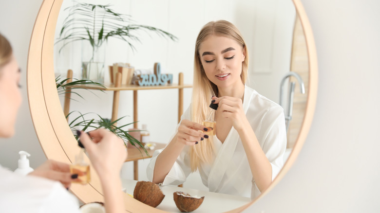 blonde woman using hydrating oil