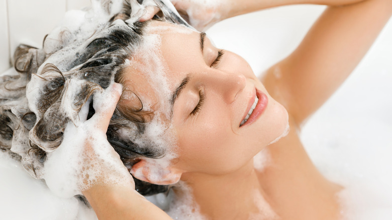 woman lathering and washing hair