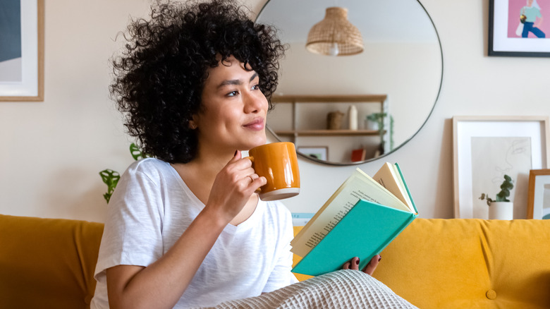 cozy woman reading on couch