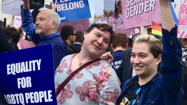 People hold signs at rally