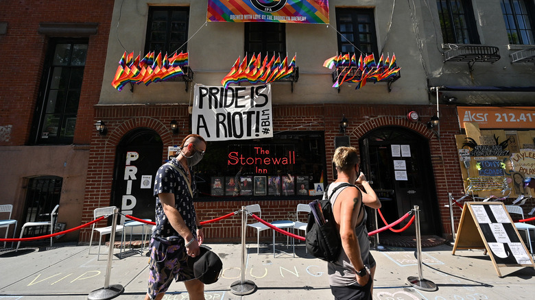 Men walk past Stonewall Inn