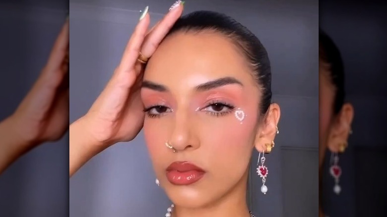 A woman with glowy pink makeup