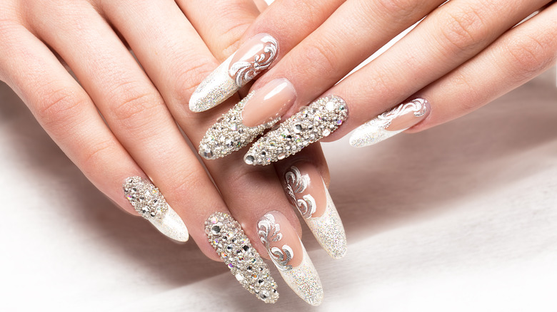 hand wearing rhinestone nails