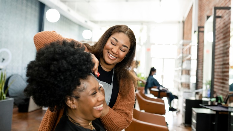 Woman smiling with stylist