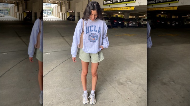 Woman wearing sweatshirt and sweatshorts