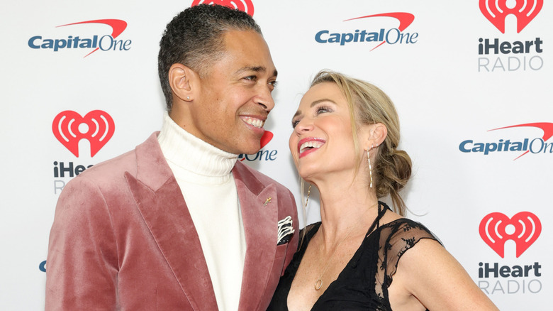 T.J. Holmes and Amy Robach stare lovingly at each other while walking the red carpet together