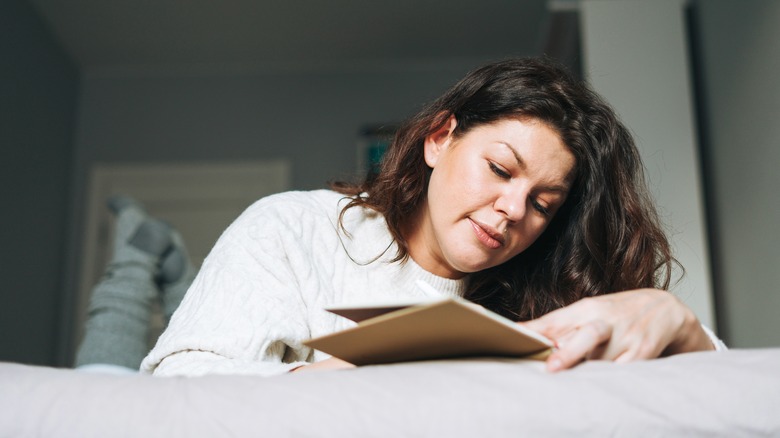 woman writing in planner