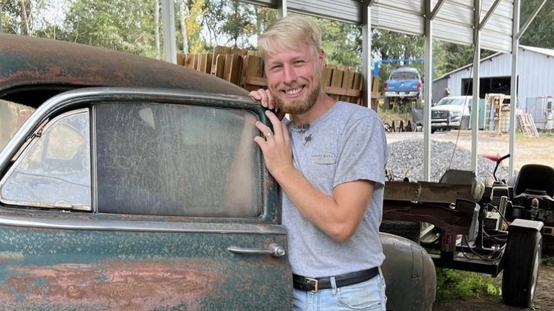 Ethan Plath smiling with car