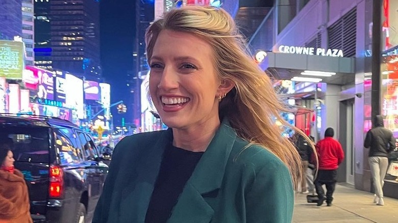 Olivia Plath smiling on city street at night