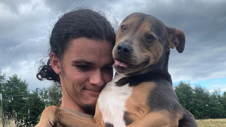 Jacob Roloff holding a dog