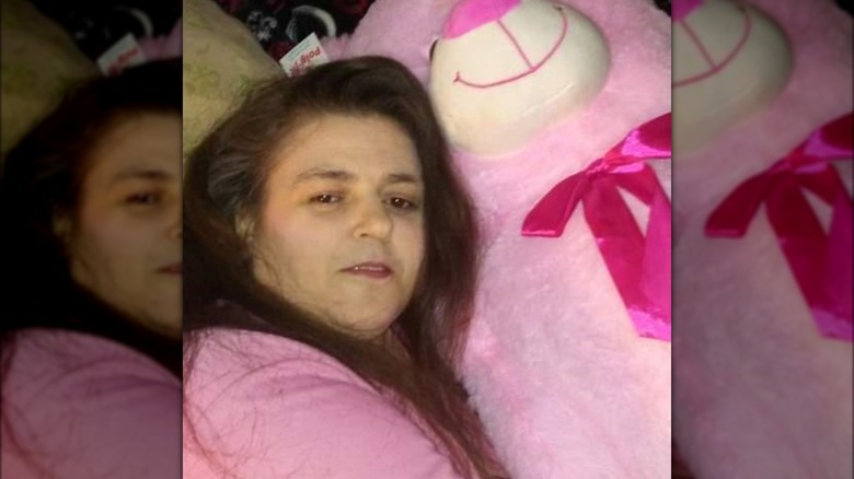 Lisa Ebberson posing with a pink plush bear 