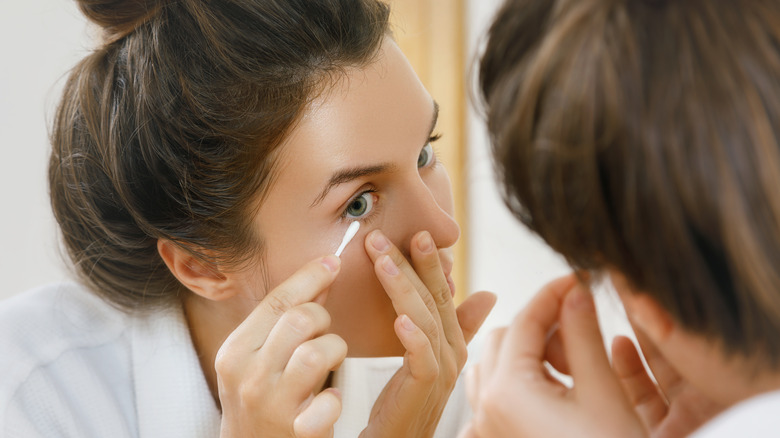 removing makeup with cotton swab