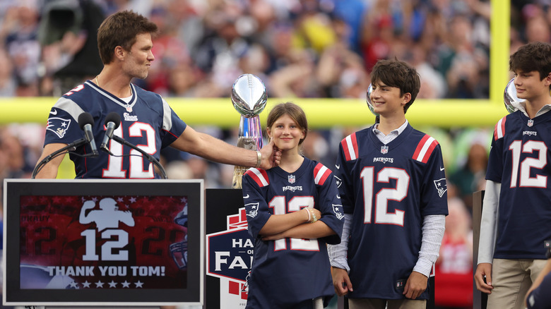 Tom Brady and his children during a 2023 halftime ceremony honoring the quarterback