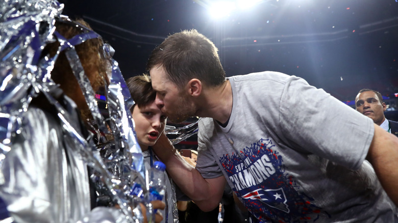 Tom Brady kisses son Jack Moynahan's forehead