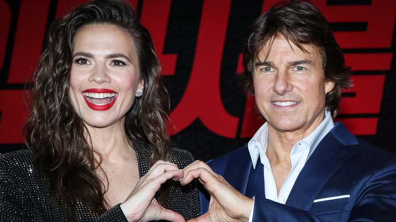 Hayley Atwell and Tom Cruise making hand heart