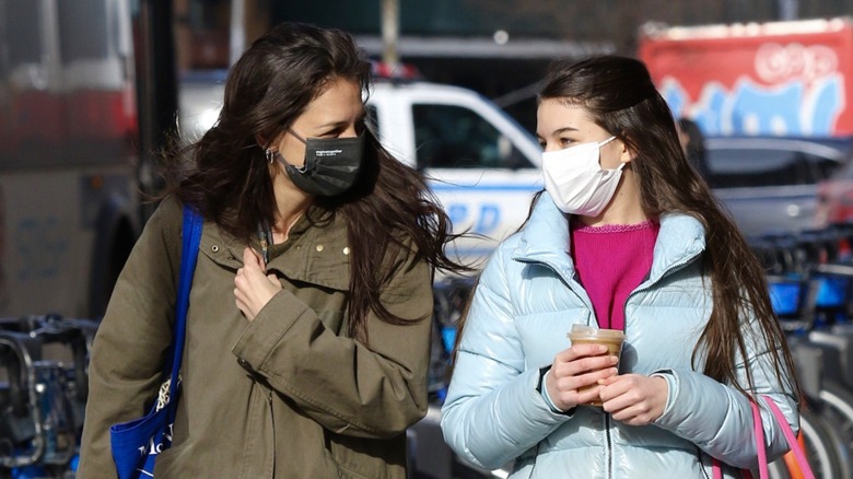 Katie Holmes Suri Cruise walking in masks