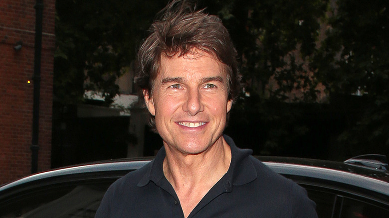 Tom Cruise dark shirt car smiling