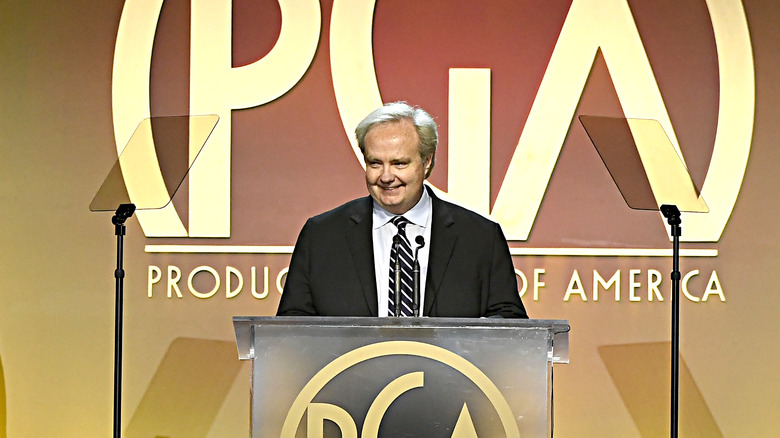 Tom Jennings smiling at podium