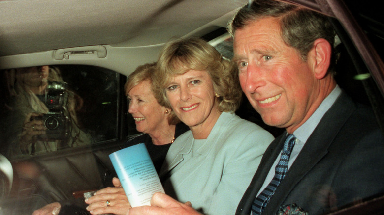 Camilla and Charles smiling in car