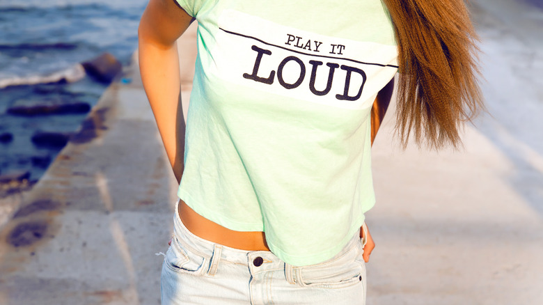 A graphic t-shirt with "play it loud" text