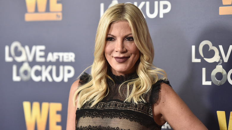 Tori Spelling smiling at a premiere event in 2019