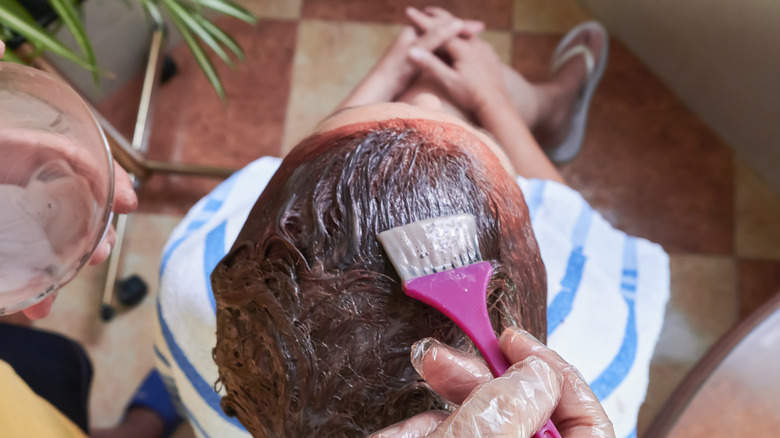 A woman having her hair dyed