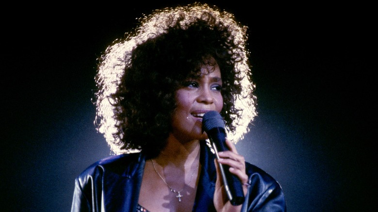 Whitney Houston singing, backlit