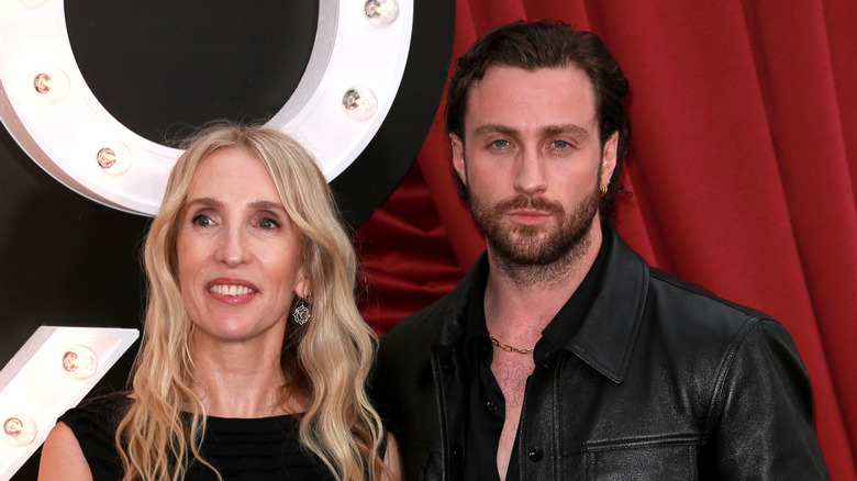 Aaron Taylor-Johnson standing beside Sam Taylor-Johnson