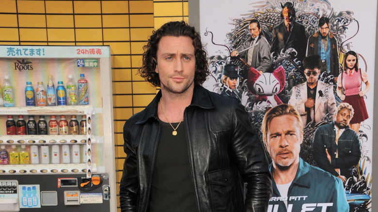 Aaron Taylor-Johnson posing in black leather jacket