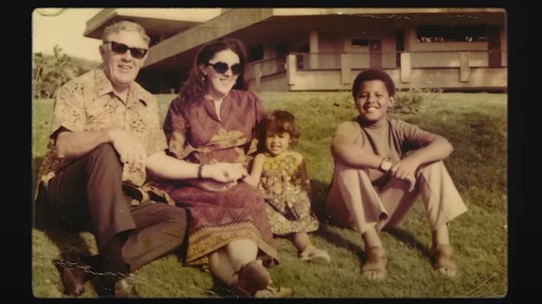 Barack Obama smiling with his grandfather, mom, and half sister Maya