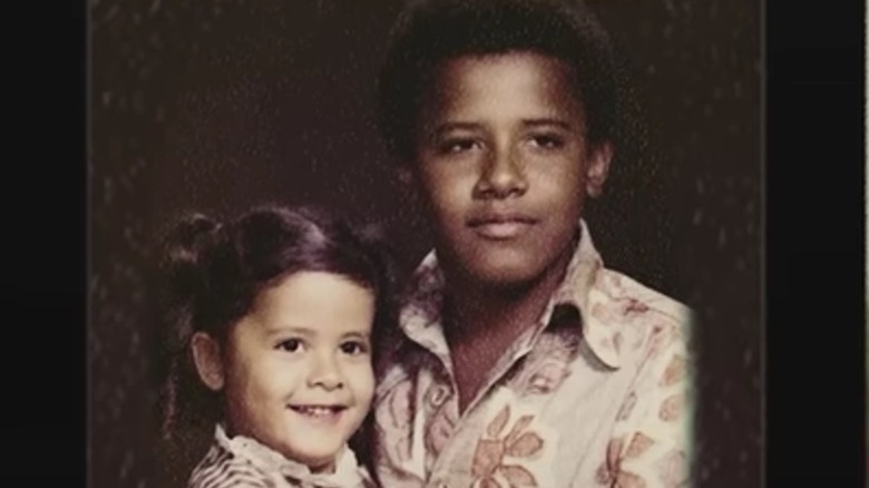 Barack Obama looking serious as a kid while his sister Maya smiles