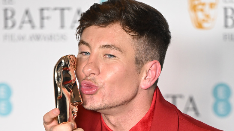 Barry Keoghan kissing his BAFTA award