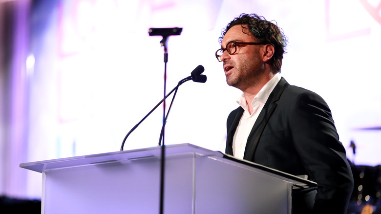 Johnny Galecki speaking at a podium